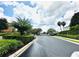 Gated community entrance featuring meticulously maintained landscaping and lush green foliage on a sunny day at 2051 Sandy Garden Ln, Winter Garden, FL 34787