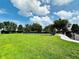 Neighborhood park with a large green space, walking path, and a fenced playground at 2051 Sandy Garden Ln, Winter Garden, FL 34787