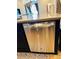 Stainless steel dishwasher seamlessly integrated into the dark kitchen cabinetry, adding both convenience and style at 2051 Sandy Garden Ln, Winter Garden, FL 34787