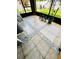 Stylish enclosed porch with decorative tile flooring and view of the backyard, creating a cozy retreat at 2051 Sandy Garden Ln, Winter Garden, FL 34787