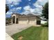 Charming home with a three car garage, brick paved driveway, and well-maintained landscaping, perfect for suburban living at 2051 Sandy Garden Ln, Winter Garden, FL 34787