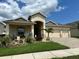 Beautiful one-story home featuring a well-manicured lawn and decorative flower beds adding curb appeal and charm at 2051 Sandy Garden Ln, Winter Garden, FL 34787