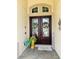 Elegant double front doors adorned with wreaths, enhancing curb appeal and offering a warm welcome to guests at 2051 Sandy Garden Ln, Winter Garden, FL 34787