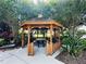 Community gazebo featuring a picnic table with seating, landscaping and shade trees at 2051 Sandy Garden Ln, Winter Garden, FL 34787