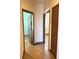 Hallway with doors leading to rooms with wood flooring at 2051 Sandy Garden Ln, Winter Garden, FL 34787