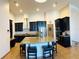 Open kitchen featuring a large island with seating, modern stainless steel appliances and dark cabinetry for a sophisticated look at 2051 Sandy Garden Ln, Winter Garden, FL 34787