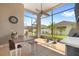 Enjoy the spacious screened-in patio with a ceiling fan, dining table, and a view of the backyard at 2051 Sandy Garden Ln, Winter Garden, FL 34787