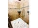 Tiled shower with decorative accent stripe and built-in shelf at 2051 Sandy Garden Ln, Winter Garden, FL 34787