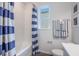 Bathroom featuring a striped shower curtain, nautical decor, and a large window at 2068 Ashwood Bluff Dr, Ocoee, FL 34761