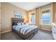 Bedroom with natural light, plush carpet, and views of a serene lake from the windows at 2068 Ashwood Bluff Dr, Ocoee, FL 34761
