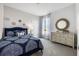 Stylized bedroom featuring blue accents, carpet flooring, and a window that allows natural light into the living space at 2068 Ashwood Bluff Dr, Ocoee, FL 34761