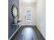 Bright foyer with wood-look floors, a mirror, and a glass front door at 2068 Ashwood Bluff Dr, Ocoee, FL 34761