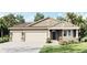 Charming single-Gathering home featuring a three-car garage, stone accents, and a welcoming front porch at 2068 Ashwood Bluff Dr, Ocoee, FL 34761