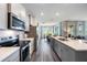 Open-concept kitchen with modern appliances, island with sink, and hardwood floors at 2068 Ashwood Bluff Dr, Ocoee, FL 34761