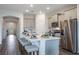 Bright kitchen with island seating, stainless steel appliances and gray cabinets at 2068 Ashwood Bluff Dr, Ocoee, FL 34761