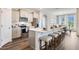 Spacious kitchen featuring modern appliances, bar seating, and hardwood floors at 2068 Ashwood Bluff Dr, Ocoee, FL 34761
