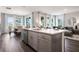 Kitchen island with gray cabinets, white countertop, sink, dishwasher, and hardwood floors at 2068 Ashwood Bluff Dr, Ocoee, FL 34761