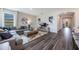 Spacious living room with hardwood floors, gray sectional couch, and a modern decor at 2068 Ashwood Bluff Dr, Ocoee, FL 34761