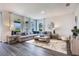 Bright living room with a comfortable sectional sofa and large windows at 2068 Ashwood Bluff Dr, Ocoee, FL 34761