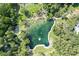 Stunning aerial view of a natural spring surrounded by lush greenery and walking paths at 211 Crown Oaks Way # 205, Longwood, FL 32779