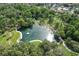 Stunning aerial view of a natural pond surrounded by lush greenery in a serene community at 211 Crown Oaks Way # 205, Longwood, FL 32779