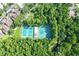 Overhead shot featuring community tennis and pickleball courts surrounded by lush trees at 211 Crown Oaks Way # 205, Longwood, FL 32779