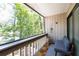 Relaxing balcony with a cozy seating area, wood-slatted floor, and peaceful views of surrounding greenery at 211 Crown Oaks Way # 205, Longwood, FL 32779