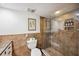 Bathroom featuring a glass enclosed walk-in shower and stylish earth-tone tile work at 211 Crown Oaks Way # 205, Longwood, FL 32779