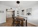 Bright dining area featuring a wood table with stools, modern lighting, and stylish wall art at 211 Crown Oaks Way # 205, Longwood, FL 32779