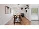Dining area with a wooden table, decorative shelving, and access to outdoor space at 211 Crown Oaks Way # 205, Longwood, FL 32779