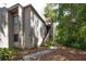 Inviting townhome featuring wood siding, stairs to the entrance and well-maintained landscaping at 211 Crown Oaks Way # 205, Longwood, FL 32779