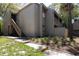 Inviting condo exterior with well-kept landscaping and stairs leading to the upper level at 211 Crown Oaks Way # 205, Longwood, FL 32779