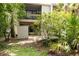 Inviting home exterior with well-maintained landscaping and a private patio area nestled among lush greenery at 211 Crown Oaks Way # 205, Longwood, FL 32779