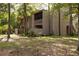Charming home exterior with a serene courtyard view surrounded by mature trees and lush greenery at 211 Crown Oaks Way # 205, Longwood, FL 32779