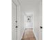 Hallway with tiled floor, crisp white walls, and modern art at 211 Crown Oaks Way # 205, Longwood, FL 32779