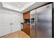 Kitchen featuring a stainless steel fridge and wood cabinets with black hardware at 211 Crown Oaks Way # 205, Longwood, FL 32779