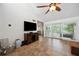 Living room featuring tile flooring, large windows, and a stylish ceiling fan at 211 Crown Oaks Way # 205, Longwood, FL 32779