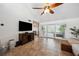 Bright living room featuring tile flooring, large windows, and a stylish ceiling fan at 211 Crown Oaks Way # 205, Longwood, FL 32779