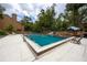 Enjoy the community pool with lounge seating and a shady umbrella area at 211 Crown Oaks Way # 205, Longwood, FL 32779