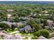 Stunning aerial view of a neighborhood featuring luxurious waterfront homes surrounded by lush greenery and mature trees at 213 N Monterey Isle, Longwood, FL 32779