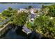 Picturesque waterfront property with a private boat dock and lake access surrounded by lush greenery at 213 N Monterey Isle, Longwood, FL 32779