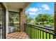 Second-story balcony offering views of the street, front yard, and neighborhood ponds, lined with mature trees at 213 N Monterey Isle, Longwood, FL 32779