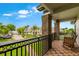 A second-story balcony with brick pillars offers views of the front yard, lush landscaping, and elegant facade at 213 N Monterey Isle, Longwood, FL 32779