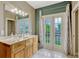 Well-lit bathroom featuring double doors that open to the outdoors at 213 N Monterey Isle, Longwood, FL 32779