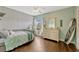 A cozy bedroom with wood floors, a daybed, and a surfboard against the wall at 213 N Monterey Isle, Longwood, FL 32779
