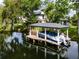 Covered boat dock with boat and lift on the waterfront at 213 N Monterey Isle, Longwood, FL 32779