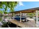 View of a covered boat lift on the water with a boat docked inside, highlighting waterfront living at 213 N Monterey Isle, Longwood, FL 32779