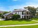 Stunning two-story home with manicured lawn, brick accents, and a charming balcony overlooking the front yard at 213 N Monterey Isle, Longwood, FL 32779