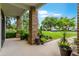Covered front porch showcases brick columns, lush landscaping, and a glimpse of the well-kept front yard at 213 N Monterey Isle, Longwood, FL 32779