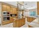 Spacious kitchen featuring a central island, built-in appliances, and tile flooring at 213 N Monterey Isle, Longwood, FL 32779